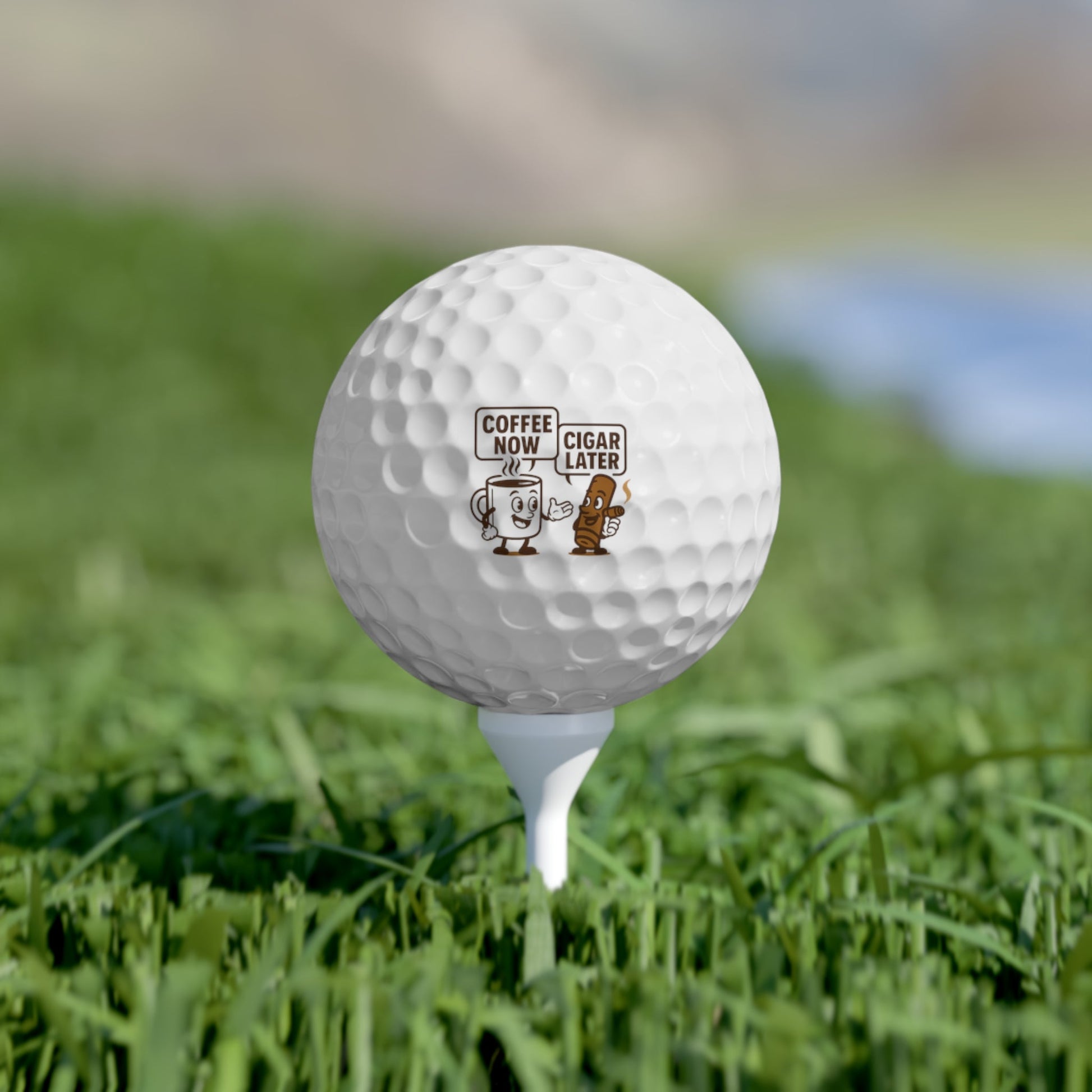 Funny golf ball with vibrant design on grassy field.