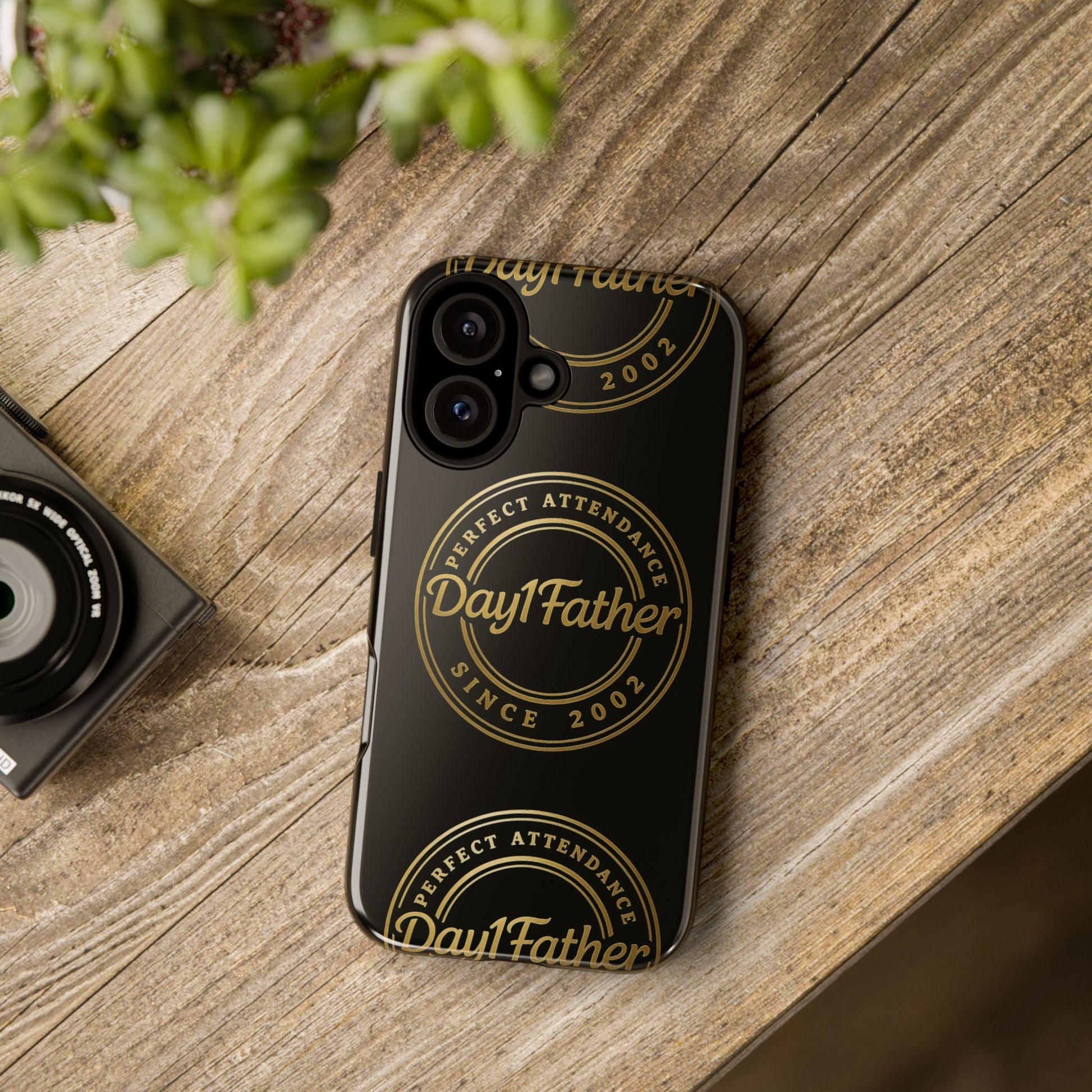 Durable phone case with sleek design and gold accents on wooden surface.