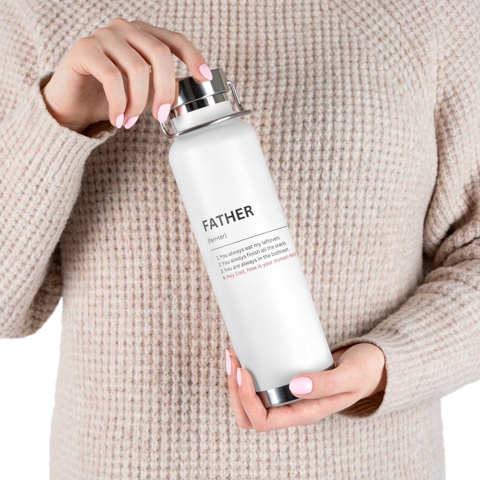22oz white insulated water bottle with funny jokes about fathers held by person in beige sweater