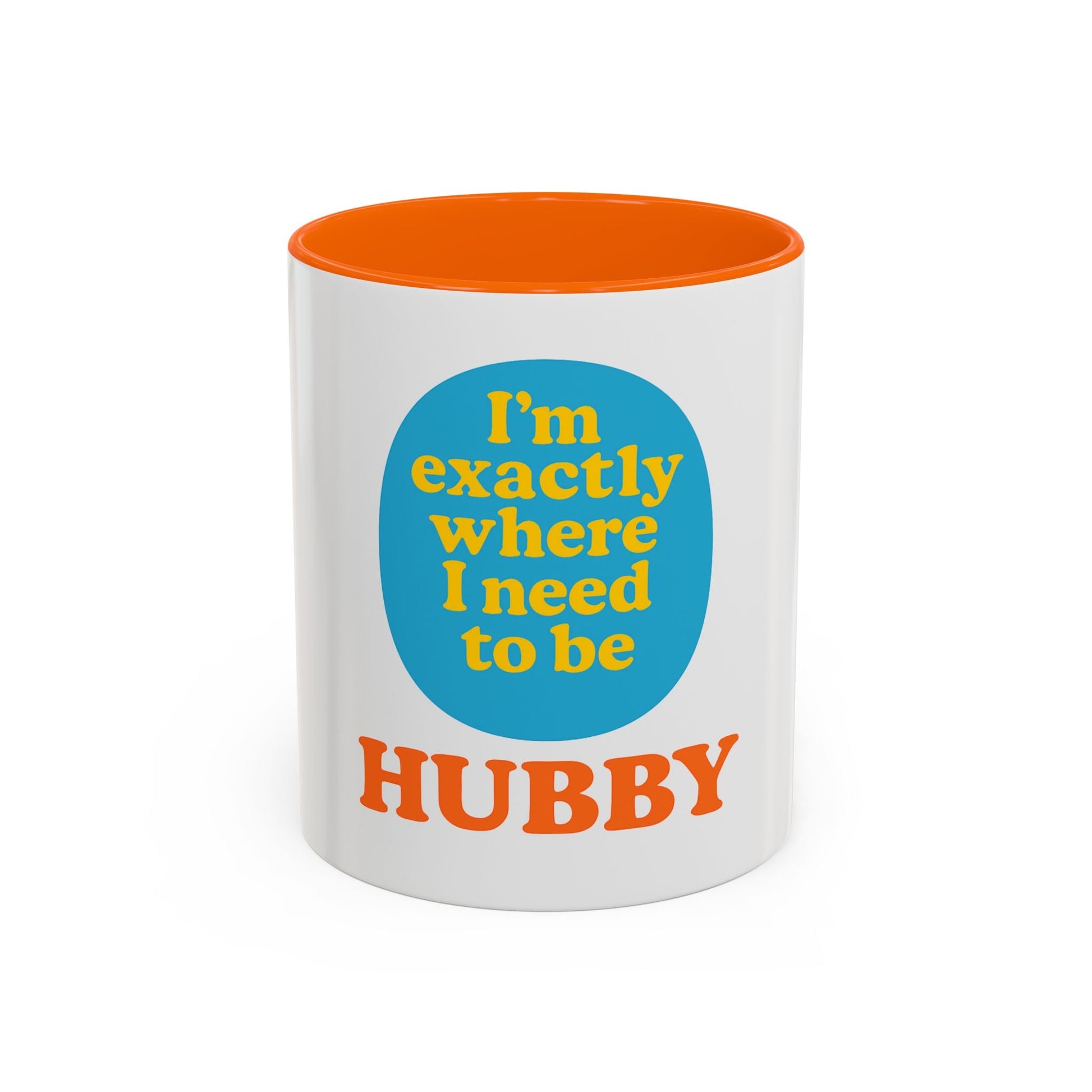 White ceramic hubby mug with orange interior featuring motivational text "I'm exactly where I need to be HUBBY" in blue and orange colors