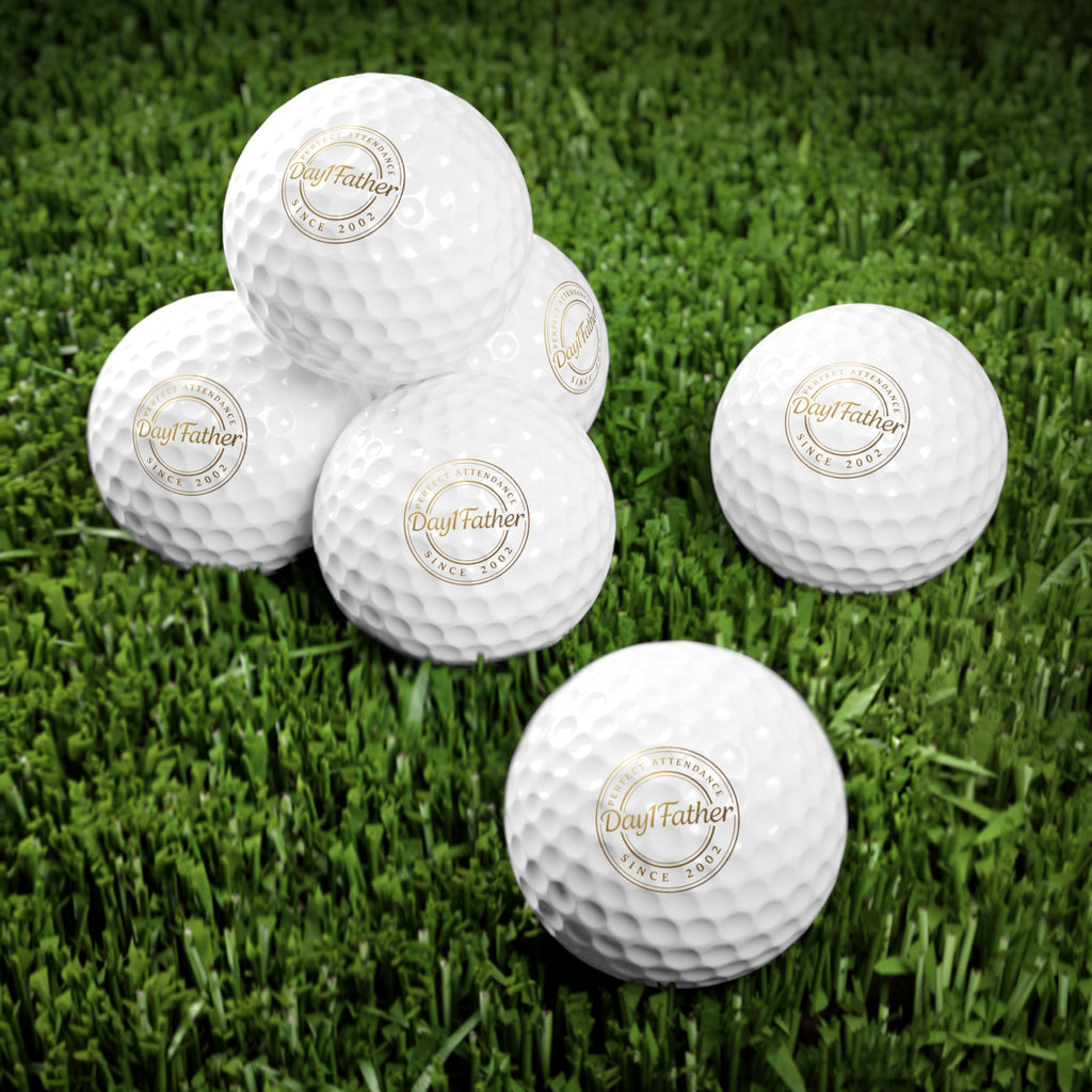 Personalized golf balls with custom logo on grass, perfect Father's Day gift for golf enthusiasts.