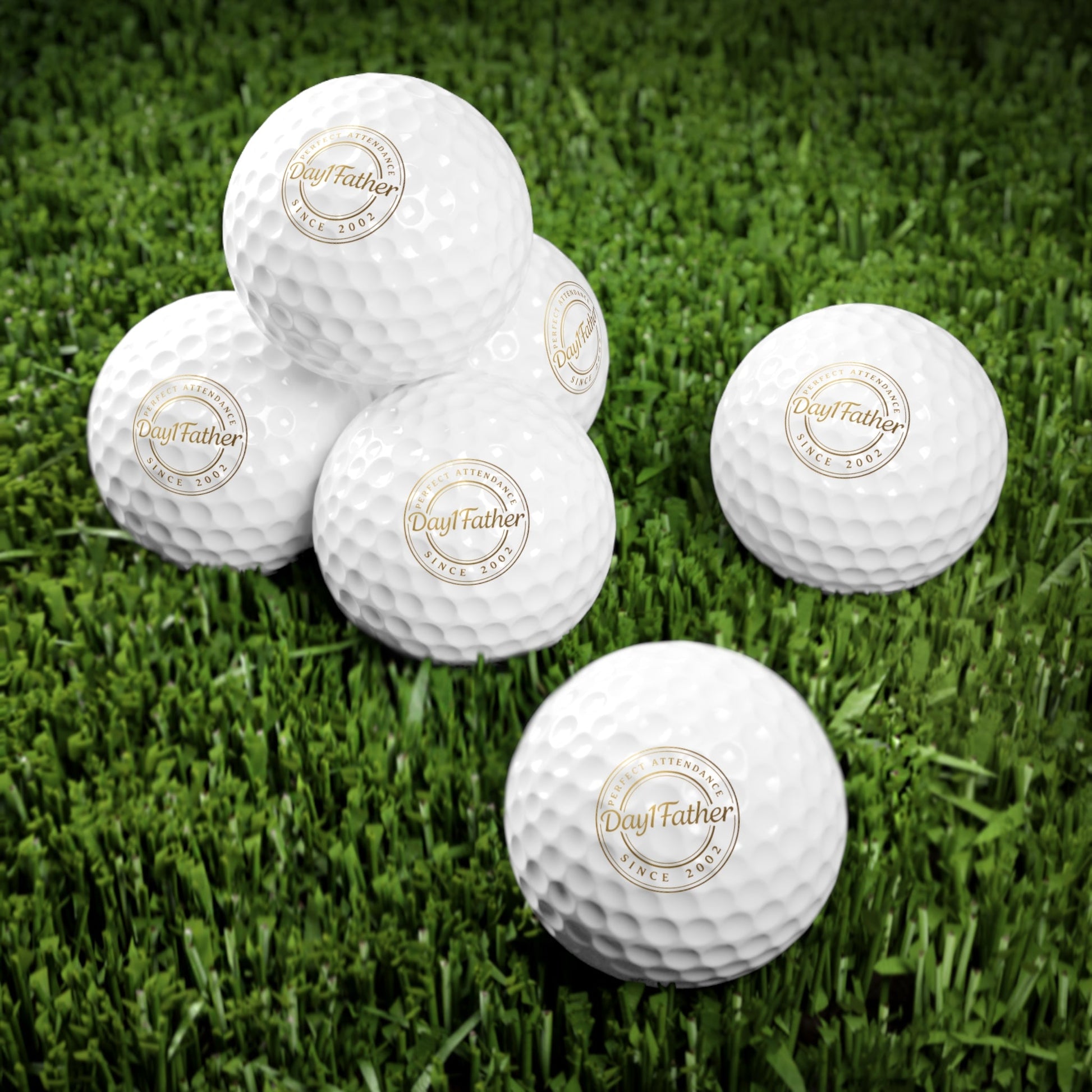 Personalized golf balls with custom logo on grass, perfect Father's Day gift for golf enthusiasts.