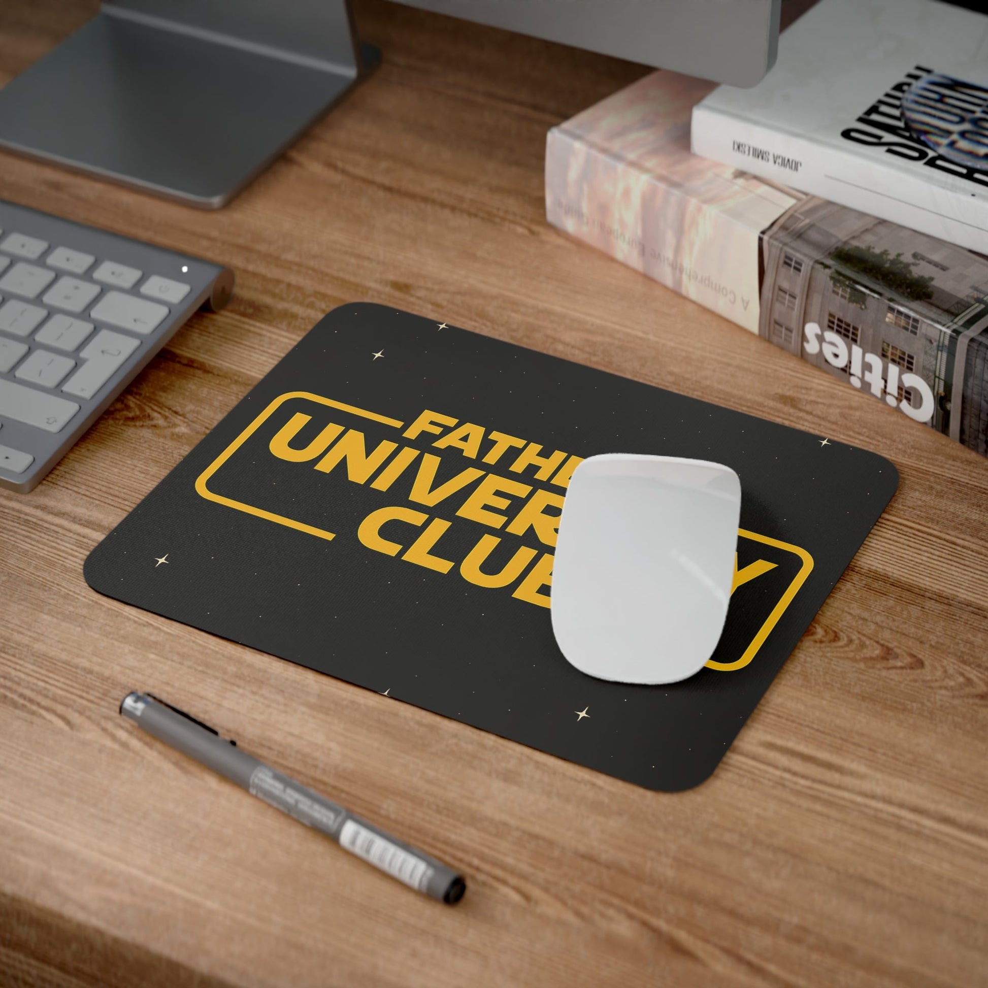Father's University Club desk mouse pad on wooden desk with keyboard and books.