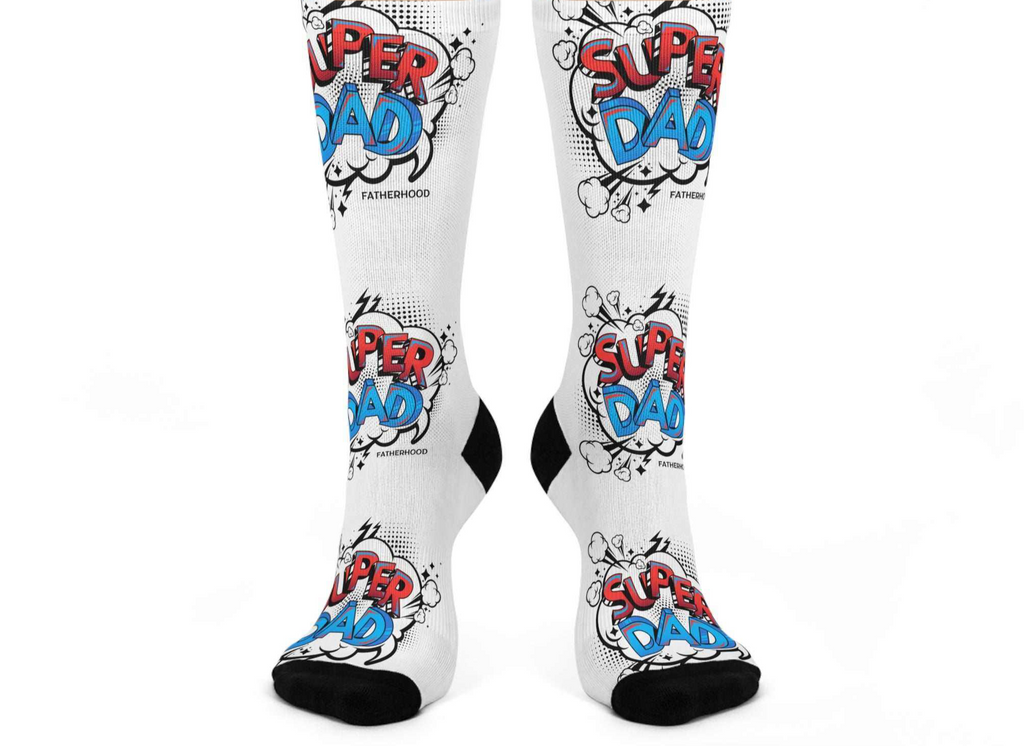White crew socks with vibrant Super Dad design in red and blue, cushioned bottoms, stretchy fabric for comfort and casual wear.